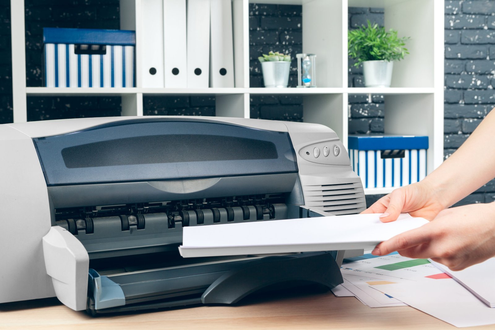 Woman making photocopy using copier in office